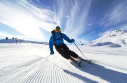 professional skier skiing on slopes in the Swiss alps towards the camera