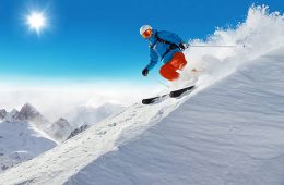 Man skier running downhill on sunny Alps slope