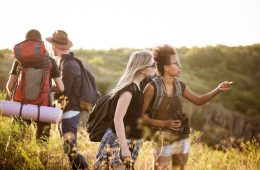 young-friends-with-backpacks-enjoying-view-traveling-canyon_176420-4523